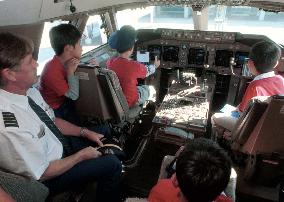 80 kids enjoy tour of jumbo jet at Narita airport